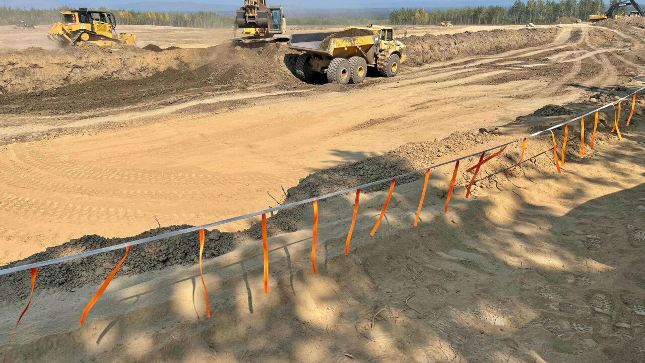 Rise Tape used as a rope guardrail at an excavation site.